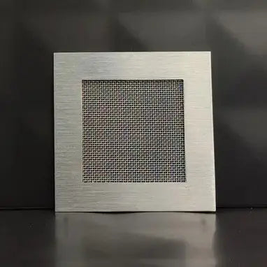 Metallic square vent on a dark background