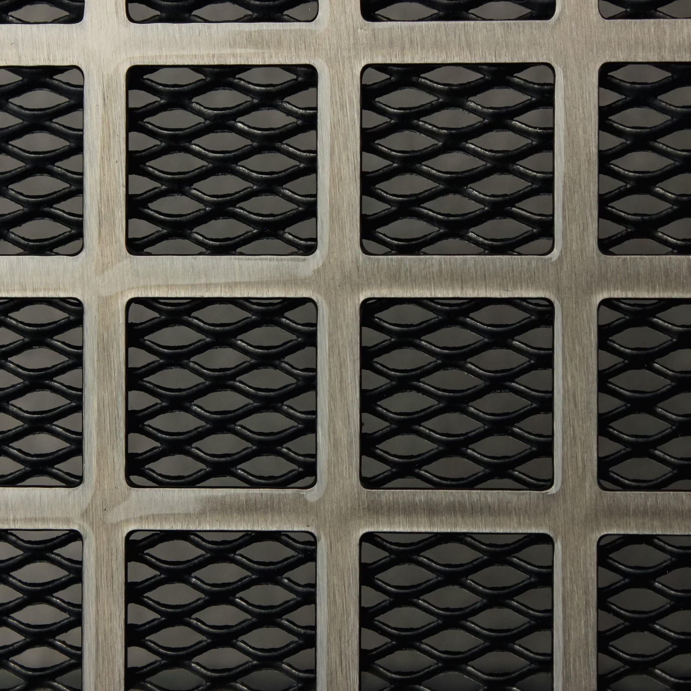 Metallic square vent  with a textured pattern on a metallic surface