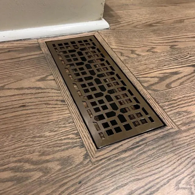 Decorative floor vent on a wooden floor