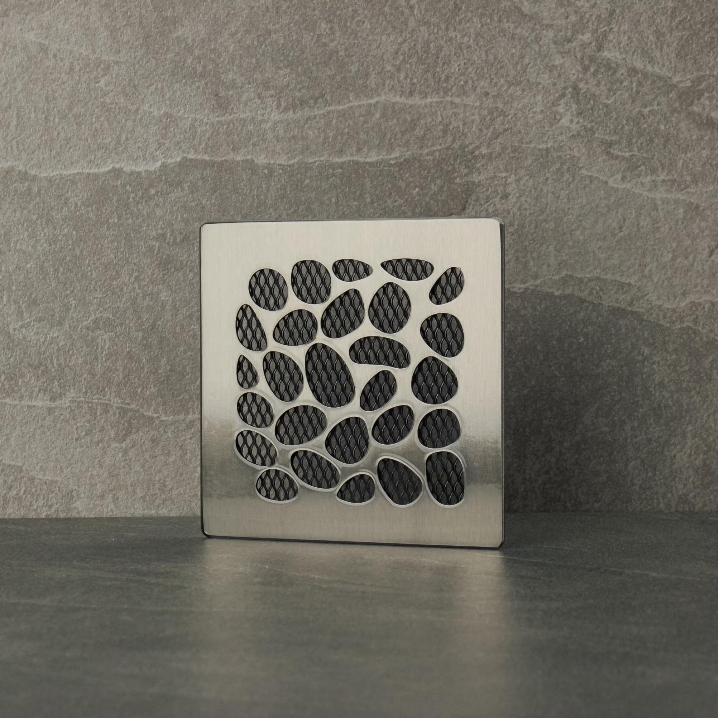 Decorative metal vent cover  with a stone pattern on a gray background