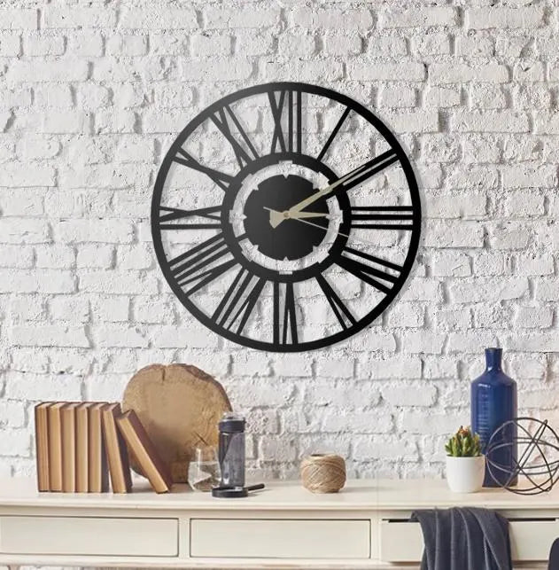 Black wall clock on a white brick wall with decorative items below.