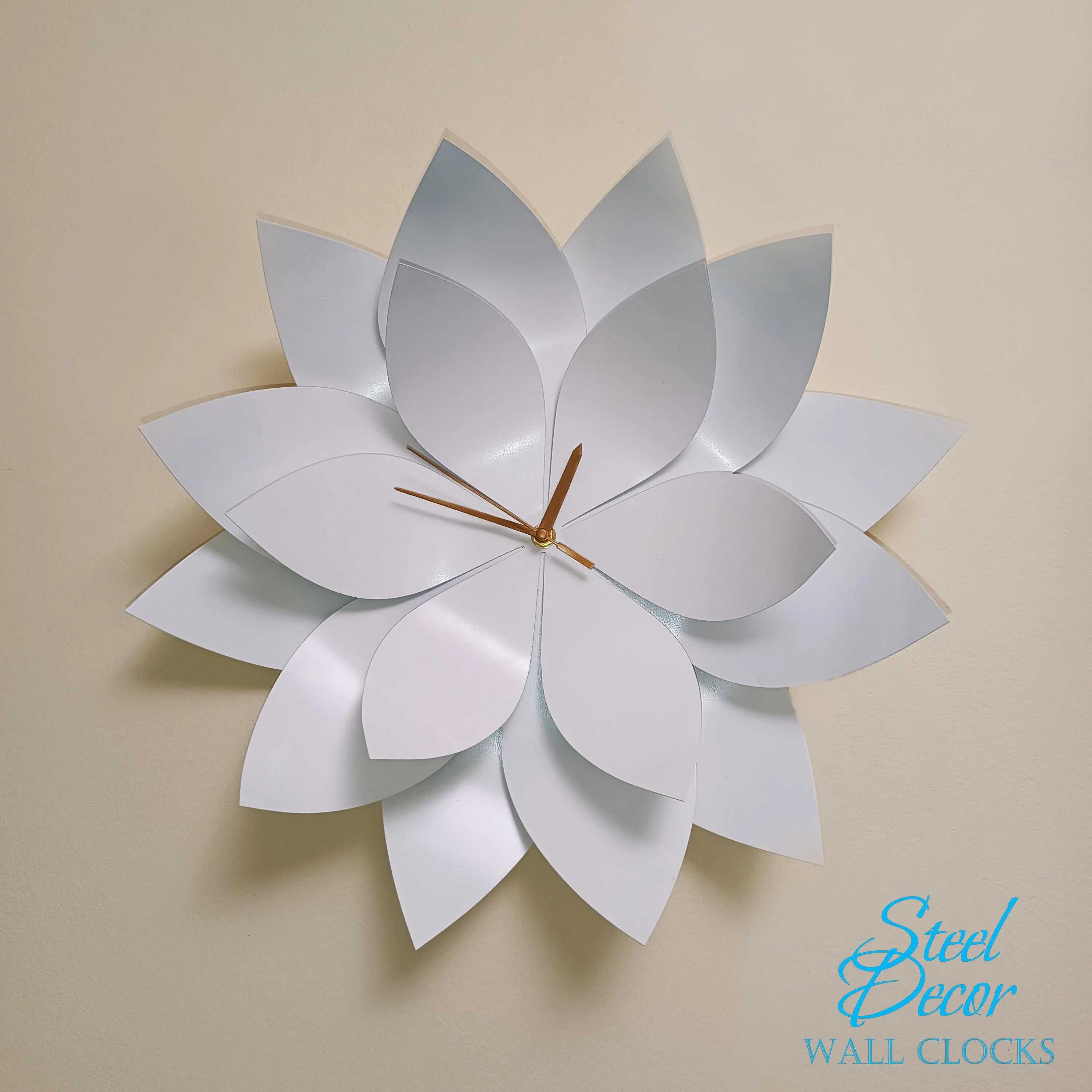 White flower-shaped wall clock on a beige background with 'Steel Decor' branding.