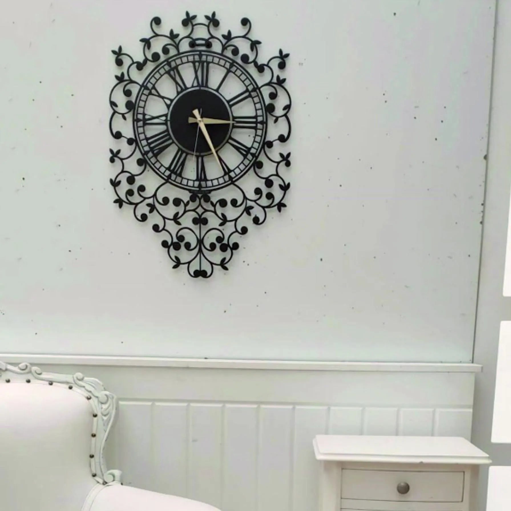 Decorative wall clock on a white wall above a bed