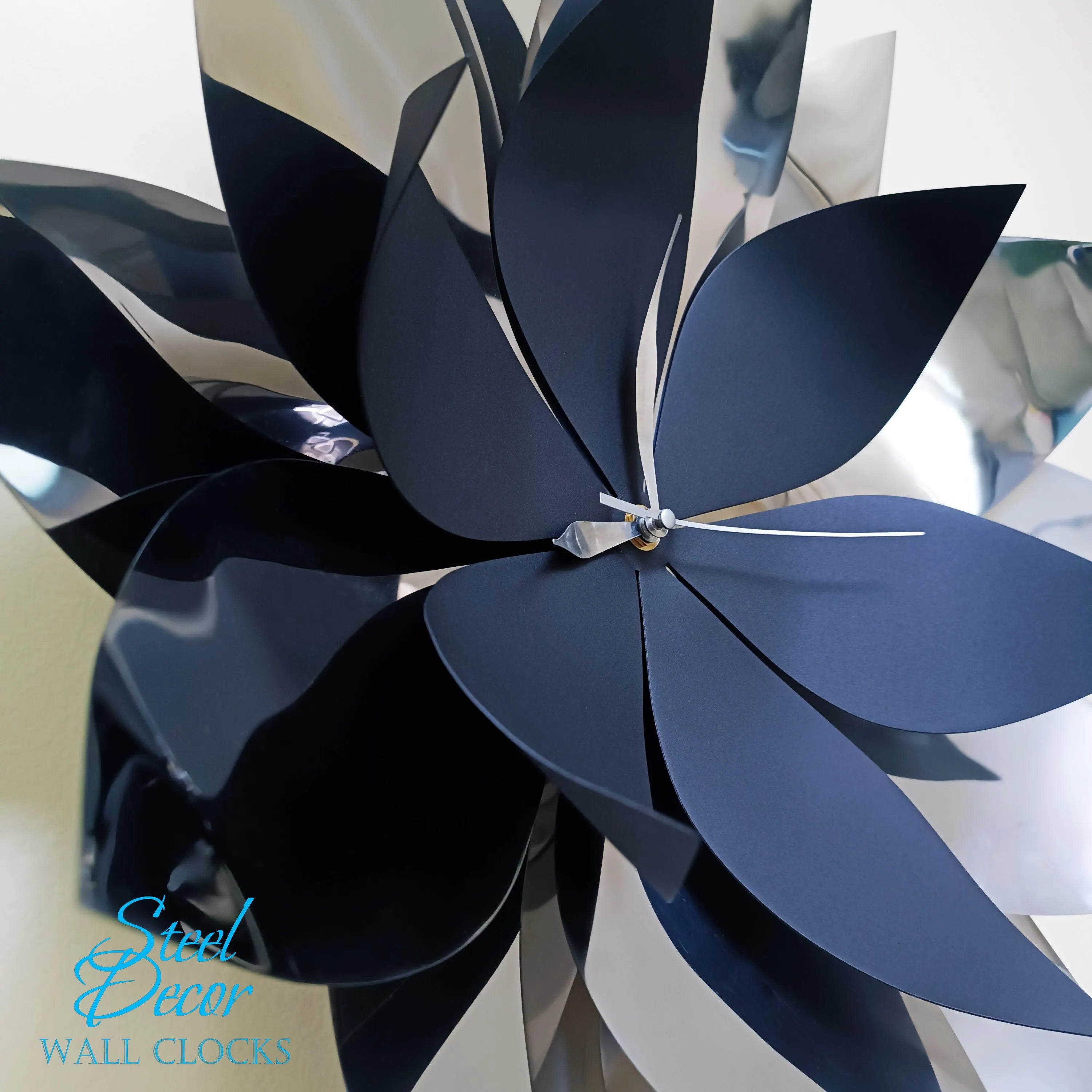 Black metal wall clock with 'Steel Decor' branding on a white background