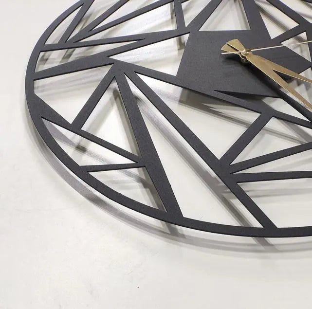 Geometric wall clock with black metal design on a white background
